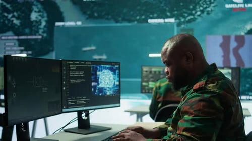 Military Specialist Monitors Satellite Data Real Time Information on Computer