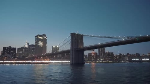 Majestic Brooklyn bridge and river at night in New York City.