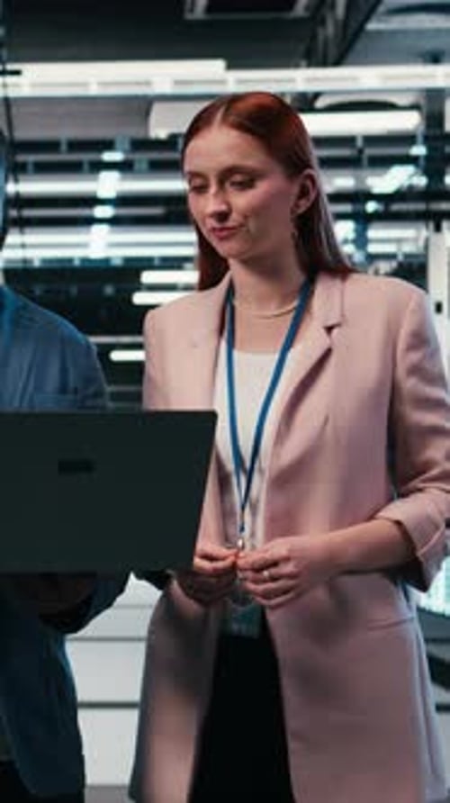 Vertical Video Doing Maintenance Laptop and Engineering Team in Server Hub