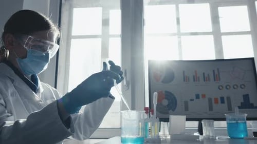 Scientist Using Pipette in Bright Laboratory