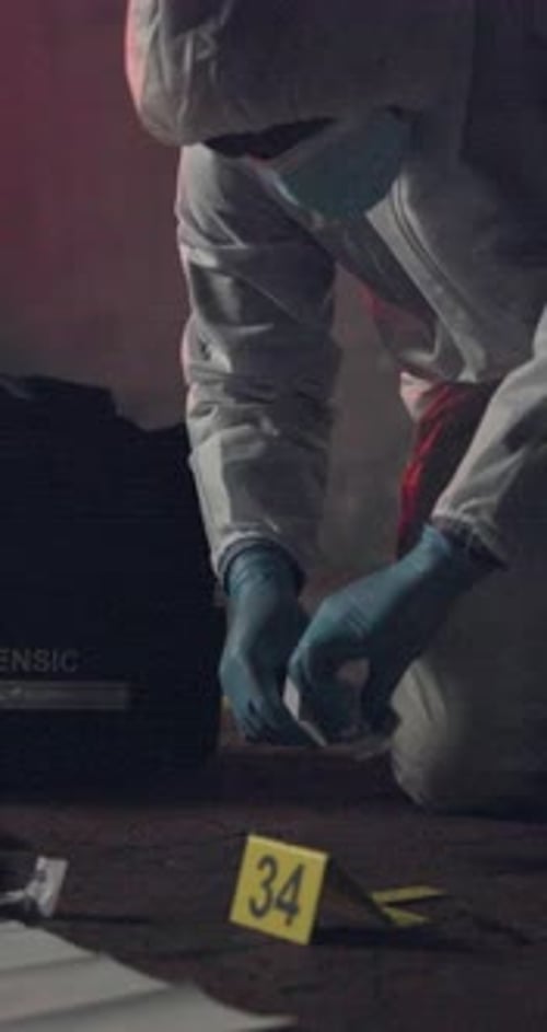 Forensic Scientist Inspecting Crime Scene Evidence at Night