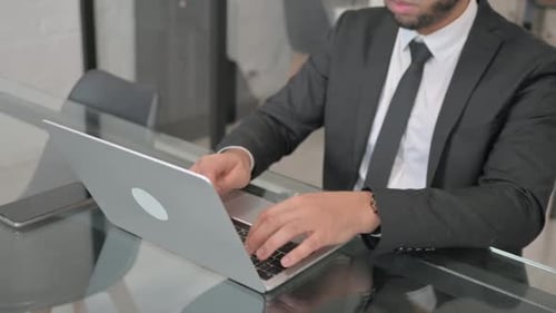Close up of Businessman Typing on Laptop