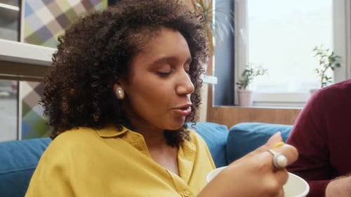 Biethnic Coworkers Communicating during Lunch in Office Cafe