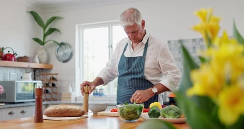 Mature Adult Cooking Vegetables in Bright Kitchen