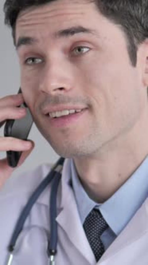 Young Doctor Talking on Mobile Phone Close-up
