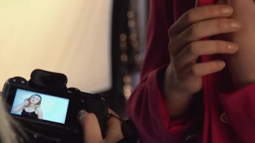 Woman Reviews Photos on Digital Camera Screen