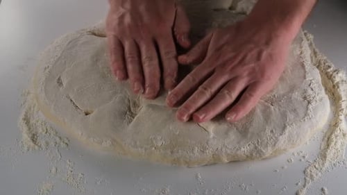 Hands Kneading Dough for Bread or Pizza
