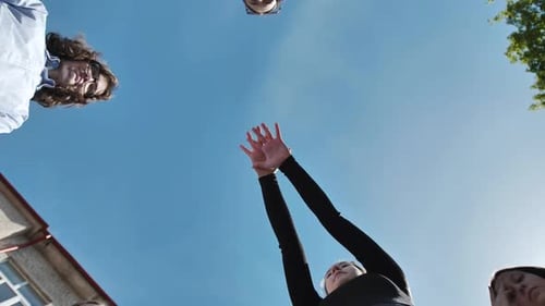 Students Coming Together in a Circle Showcasing Unity Teamwork and Collaboration on a Sunny School