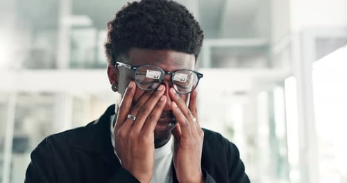 Frustrated, black man and eye strain with stress in office for overworked pressure or anxiety