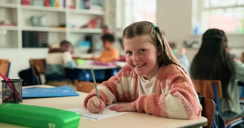 Happy, writing and face of student in classroom at elementary school for learn