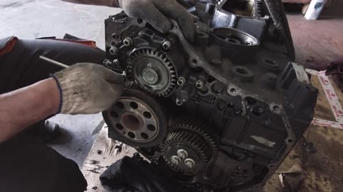 Engine Repair with Gloves and Tools