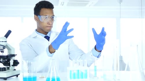 Scientist Working in Modern Bright Laboratory with Beakers