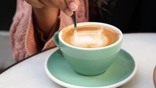Close Up of Coffee Being Stirred with Spoon