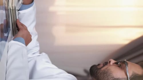 Doctor Taking Notes in Bright Medical Setting