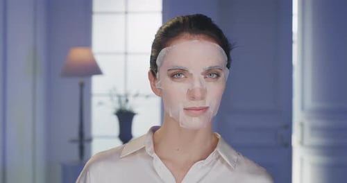 Beauty shot of young woman wearing paper sheet facial mask ready for moisturizing anti wrinkle day