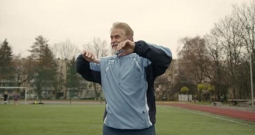 Senior Man Doing Exercises at the Stadium