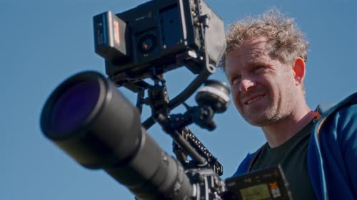 Man Holding a Professional Camera in Natural Light
