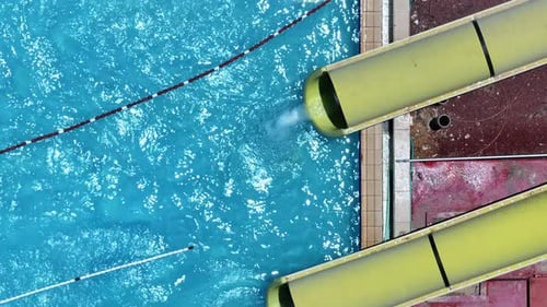 Aerial view of people sliding down a water slide at a water park