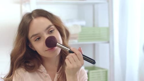 Sensual Woman Applying Powder with Cosmetic Brush While Morning Makeup in Bathroom