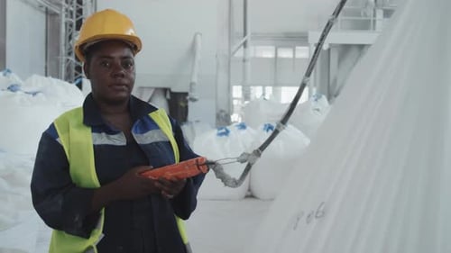 Female Factory Worker Using LIfting Hoist
