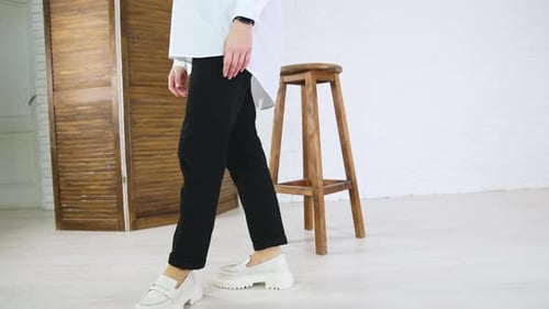 Woman Models Shoes and Clothing in Studio Setting