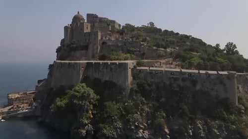 Ischia, the Aragonese castle on the island of Ischia in the background of the island of Naples, in I