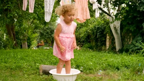 The Child is Washing Clothes in the Garden Selective Focus