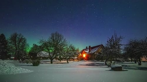 A magical winter landscape shows a house and garden under the snow and in the background the norther