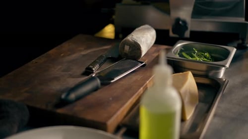 Closeup in Restaurant in a Rib Bar Cutlery Iron Tray with Lying Hard Parmesan Cheese and a