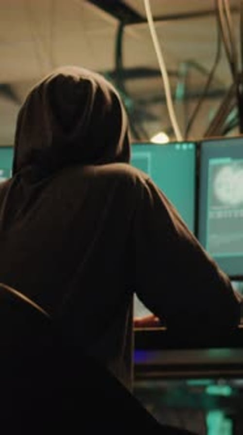 Hacker Working on Computer in Dark Workspace