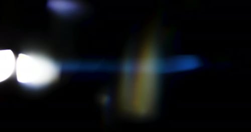 Beautiful, stunning light reflections and anamorphic blue streaks shot on black with high-end cinema