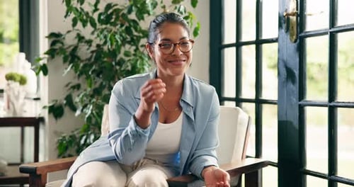 Smiling Woman Sitting and Laughing in a Chair