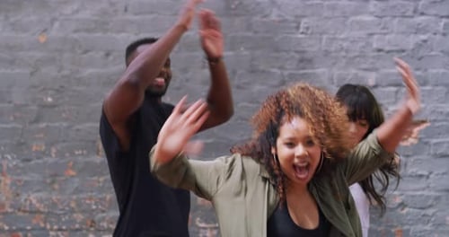 Friends Dancing Together in Urban Setting