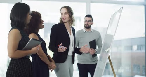 4k video footage of a group of businesspeople brainstorming on a whiteboard in an office