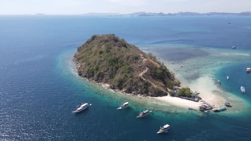 Aerial view of beaches and tourist boat sailing in Kelor Island, Flores Island, Indonesia.