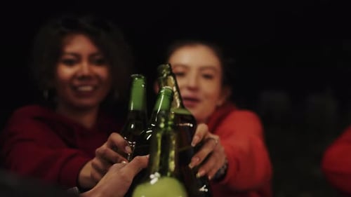 Young Multiracial Friends Close Up Sitting in the Circle at the Cheerful Outdoor Summer Party at