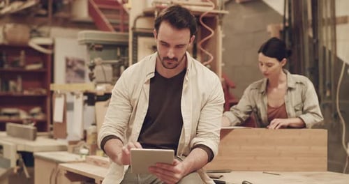 4k video footage of two young carpenters working in their woodworking workshop