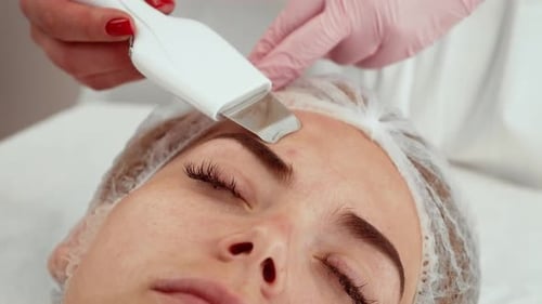 Beautician Using Ultrasonic Facial Device for Deep Cleansing at Cosmetology Studio Expert Conducting