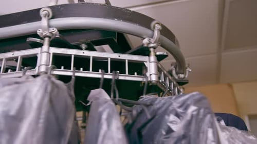 industrial laundry in hotel clean shirts of employees and guests sorted after washing hung scrolled