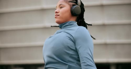 Fitness, cardio and headphones with woman and skipping rope in city for workout