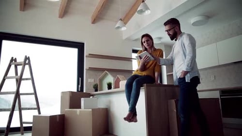 Couple Plans Home Decor on Tablet in New House