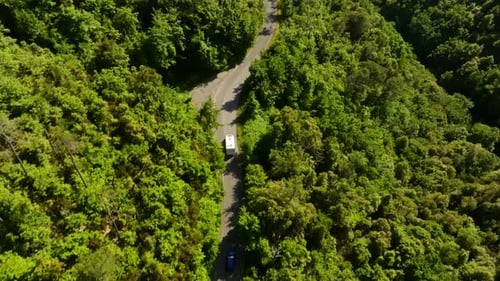 Aerial view overlooking a RV driving on a high altitude road in Liguria, Italy