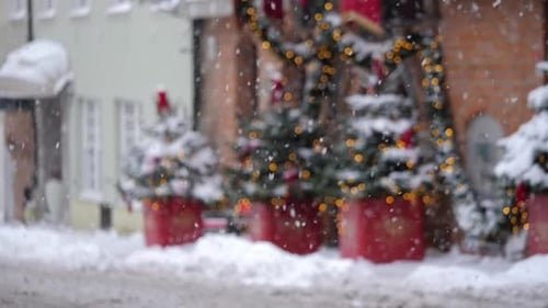 Slowmotion View of Snowflakes Falling Christmasdecorated Street in the Background