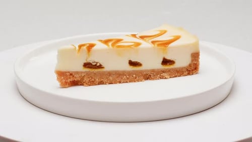 Delectable Caramel Cheesecake Rotating on White Plate