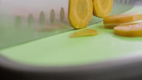 Chopping Carrot Into Slices on Cutting Board