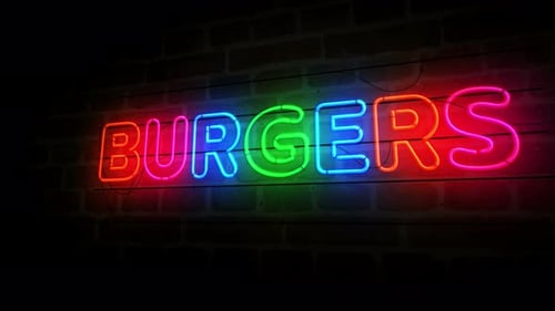 Burgers bar neon symbol on brick wall