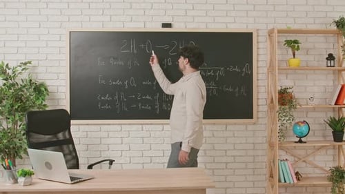 Man Explains Chemical Equation on Blackboard