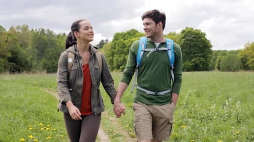 Travel, Hiking, Backpacking, Tourism and People Concept - Happy Couple with Backpacks
