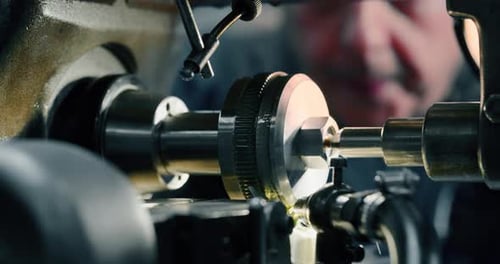 Slow motion macro of specialist is working on production of different gearing details in a worksho