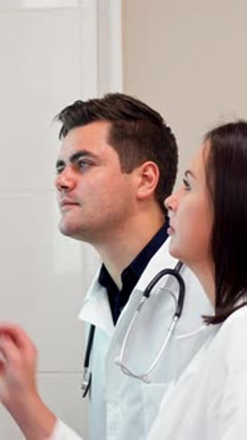 Dedicated Medical Team Analyzing Xray Images on a View Box